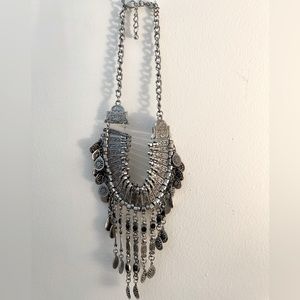 Bold, chunky silver necklace.